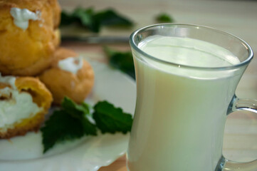 Custard cookies and milk, golden eclair filled with whipped cream