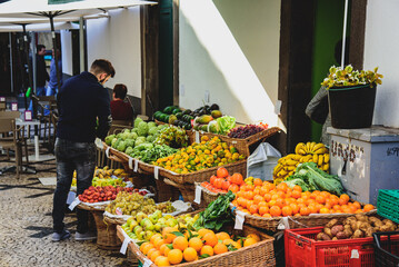 Funchal, Madeira Island I Portugal
12-21-2017. Tropical fruits on the famous market in Exotic fruit. Colorful food, healthy lifestyle. Banana, mango, passion fruit or avocado.