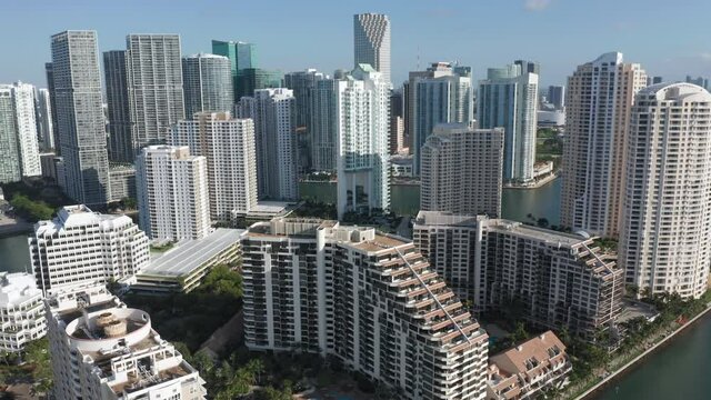 Inspirational aerial view on the seascape from the residential area point. Port of Miami is visible in the distance. 4K aerial drone video of the seafront apartments, Florida, USA