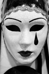 White Pierrot mask, made by hand, with sad emotional expression, traditional Venetian products. Tourism products Italy. black and white