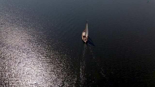 High Aerial of traditional sailboat sailing over sea