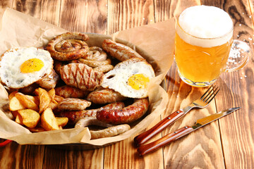 beer snacks set on wooden background top view with beer in glass closeup and copy space