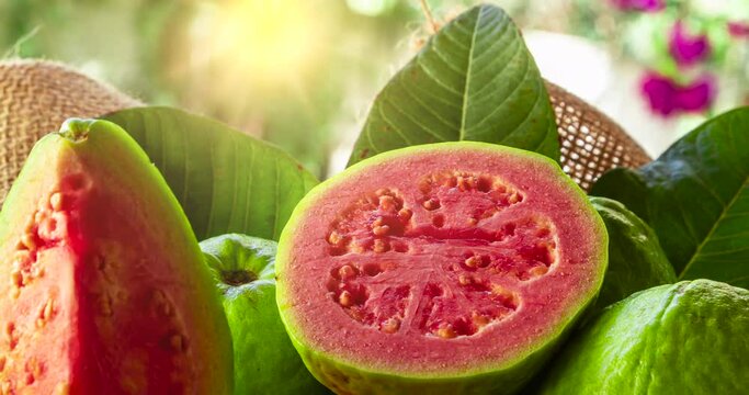 Red guavas sliced and sunset in the background