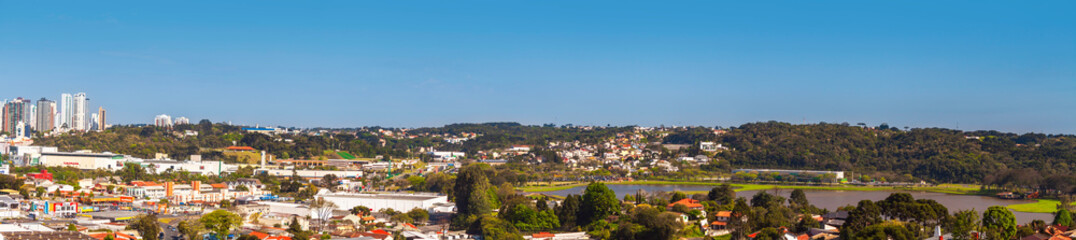 Fototapeta na wymiar Curitiba, Parana, Brazil - 21 September 2013: Panoramic view from city park. Barigui Park and surroundings in a sunny day. Urban cityscape. Modern city in South America.