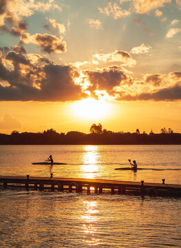 Silhouette of people watching the sunset from the wood pier in Ermida Dom Bosco, Bras&iacute;lia, Distrito Federal, Brazil. Dramatic sunset at Lago Parano&aacute;.