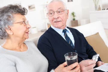 old couple taking a medication at home