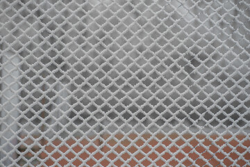 metal fence pattern covered in ice