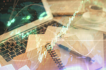 Double exposure of financial chart drawing and desktop with coffee and items on table background. Concept of forex market trading