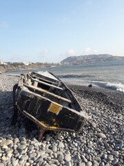 Abandoned row boat on a beach in Lima Peru