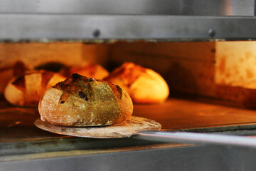 Bread freshly made. Out of a traditional brick oven. process of making bread