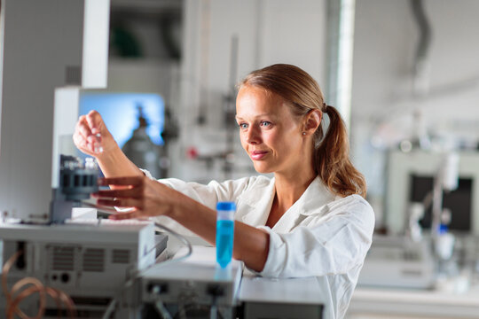 Portrait of a female researcher doing research in a lab, using a tablet computer for data collection and visualization(shallow DOF; color toned image)