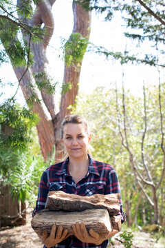 Woman holding pile of firewood