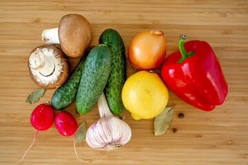 Fresh organic vegetables mushrooms on wooden table background flat lay