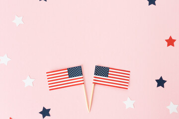 Two usa flag toothpick and star around on pink background, flat lay. 4th of july in America, celebration independence day in usa. Copy space for text in center. - obrazy, fototapety, plakaty