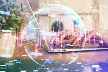 Double exposure of woman hands typing on computer and forex chart hologram drawing. Stock market invest concept.