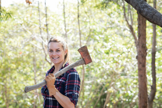 Woman chopping wood outdoors