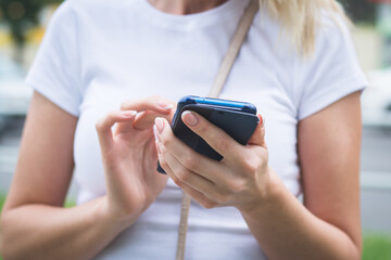 Close up photo of female hands touching screen smartphone