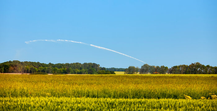 Landscape in the agricultural region of the heart of France, Beauce, with an irrigation system in operation.