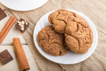 homemade oatmeal cookies with a cup of cocoa on a white wooden background. side view, selective focus.