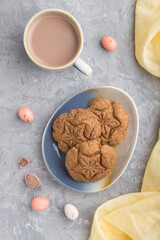homemade oatmeal cookies with a cup of cocoa on a gray concrete background. top view, close up.