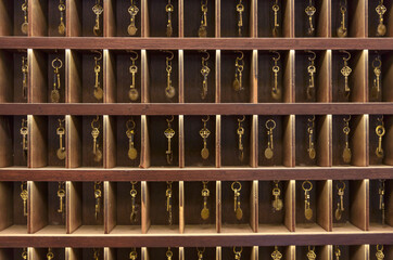 Retro keys in wooden storage, hotel reception, old vintage style, all keys in a place - obrazy, fototapety, plakaty