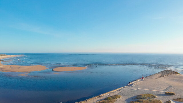 Aerial view of the two sides of Restinga de Ofir. The Ronca de Esposende, a red and white colored beacon alerts on the pier, Portugal.