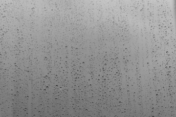 grey glass with raindrops background