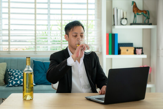 Asian Man Virtual Happy Hour Meeting Party And Drinking White Grape Wine Online Together With His Friend In Video Conference With Digital Tablet For A Online Meeting In Video Call