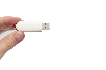 USB flash drive close up shot held between fingers by Caucasian male hand isolated against white 2020