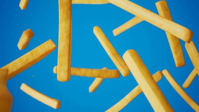 French fries tumbling in 3D space on blue background