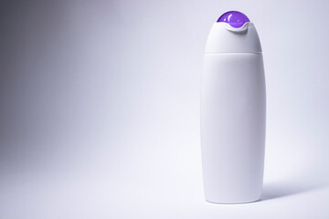 white shampoo bottle with purple neck and no label. body care and beauty concept. Copy space. High quality photo