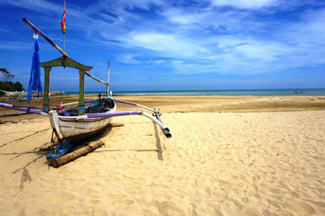Fototapeta premium Sailboat on the sand, sailboat lie on the beach waiting for a sailor. 