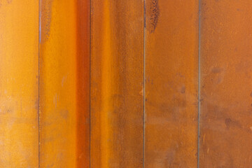 Rusty metal background. Orange and brown metal texture. Old metal iron panel.
