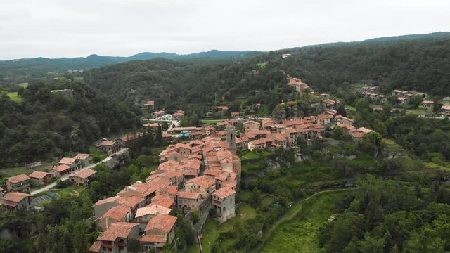 A drone shot of the rural town of Rupit i Pruit, in Catalonia, Spain. The aerial views shows almost all the village.