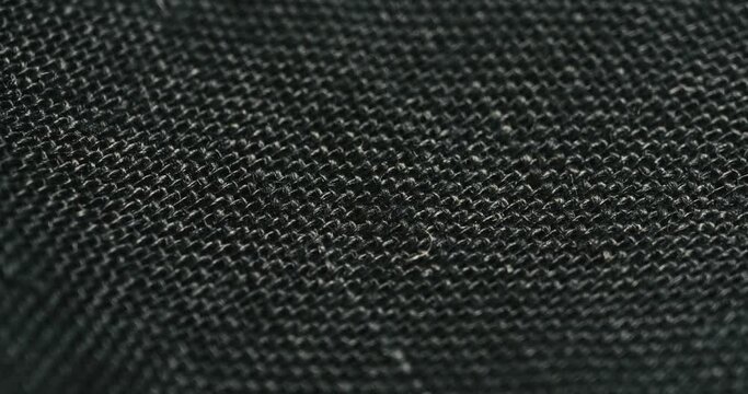 4K Black Woven Fabric Texture Rotating in Macro, Cinematic Luxury Detail for Clothing Furniture Automobiles