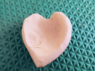 a piece of fresh coconut shaped into a heart shape on the table
