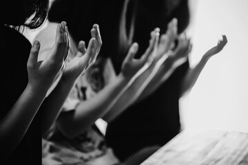 Black and white of group people praying worship believe.