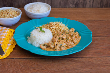 Food plate with shrimp stroganoff. Wood background.