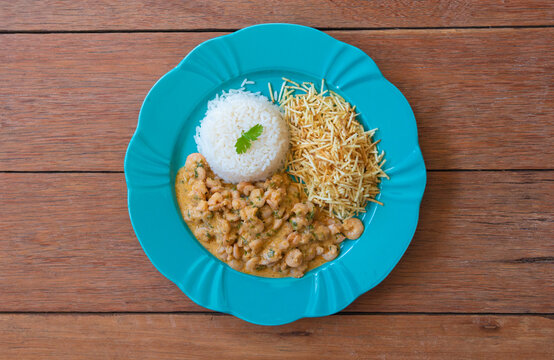 Food plate with shrimp stroganoff. Wood background.