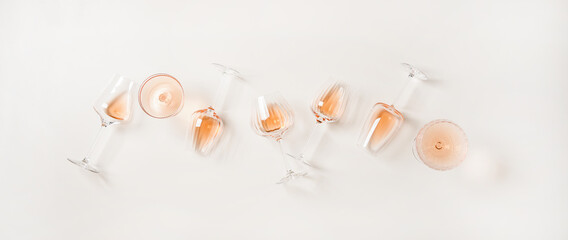 Rose wine variety layout. Flat-lay of rose wine in various glasses over plain white background, top view. Summer drink for party, wine shop or wine tasting concept - obrazy, fototapety, plakaty