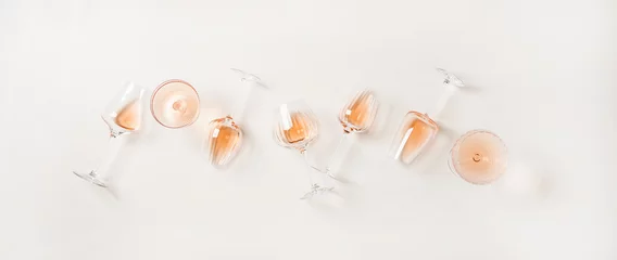 Foto op Canvas Rose wine variety layout. Flat-lay of rose wine in various glasses over plain white background, top view. Summer drink for party, wine shop or wine tasting concept © sonyakamoz