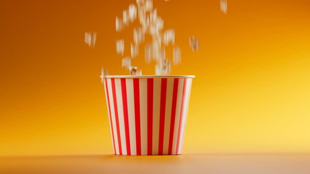 Footage of poping up corn seeds. A popcorn jumping out from striped bucket. Fun