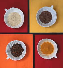 Spices and grains in white cups on colorful napkins. Top view