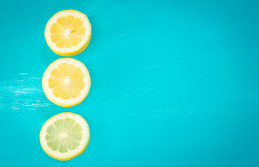 Turquoise background with three lemon slices