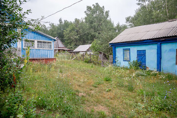 Fototapeta na wymiar An old village in the Bashkir outback. Wooden houses and dirt paths. Russia, Bashkortostan.