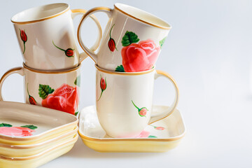 Cups, plates, bowls on white background