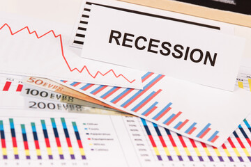 Inscription recession, currencies euro and downward graphs representing financial crisis caused by coronavirus. Global recession.