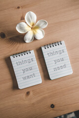 Fototapeta na wymiar notepads with titles Things you need vs things you want side by side on desk ready for meditation