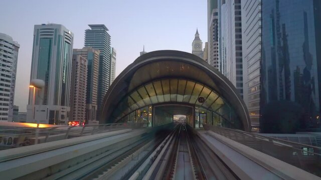 Dubai Metro Arriving At The Station With A View Of Downtown Skyline During Sunset In Dubai, UAE.  - POV - wide rolling
