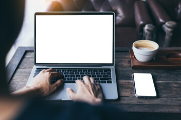 computer,cell phone mockup image.hand woman work using laptop texting mobile.blank screen with...